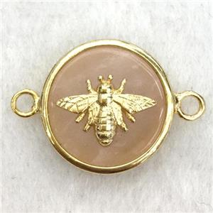 peach sunstone circle connector with honeybee, approx 15mm dia